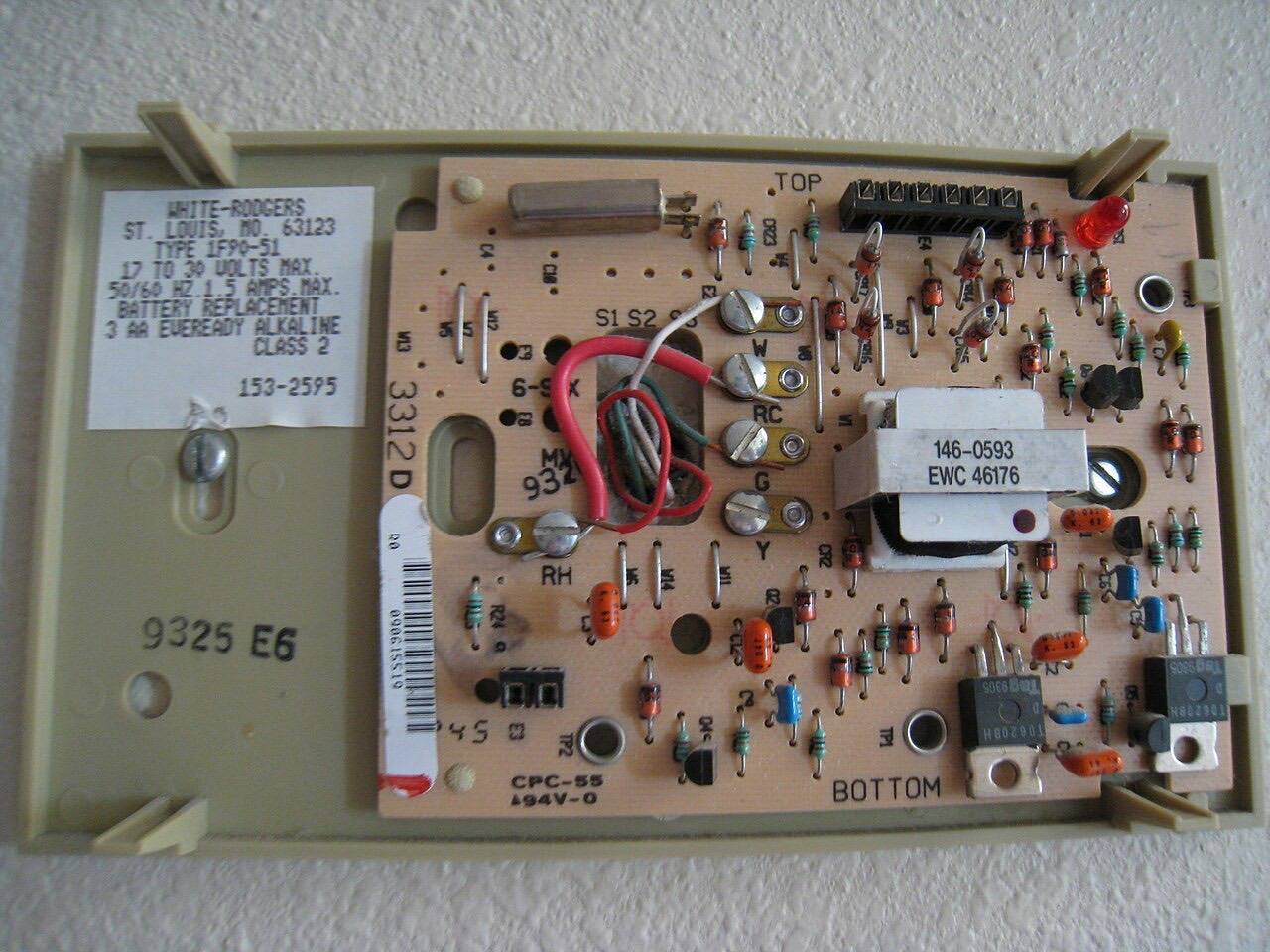 The wall-mount portion of a digital thermostat, with the cover off.